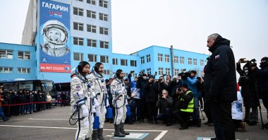 Japanese billionaire Yusaku Maezawa (L), his assistant Yozo Hirano (3L) and Russian cosmonaut Alexander Misurkin report to the head of Russia's Roscosmos space agency, Dmitry Rogozin, prior to the launch at the Baikonur cosmodrome, Kazakhstan, Dec. 8, 2021. (AFP Photo)