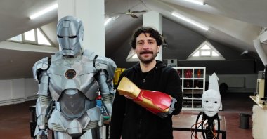 Tolga Özuygur poses with the bodysuit and the arm he designed, in Istanbul, Turkey, Dec. 19, 2021. (İHA PHOTO)