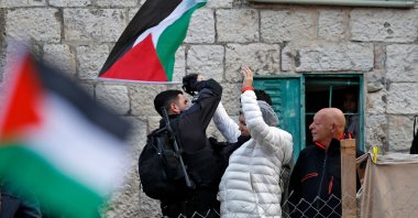 A Palestinian resident scuffles with a member of Israeli security forces during a demonstration in the east Jerusalem neighbourhood of Sheikh Jarrah, East Jerusalem, December 17, 2021. (AFP Photo)