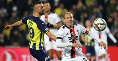 Fenerbahçe's Serdar Dursun (L) vies for the ball with Beşiktaş's Domagoj Vida during a Süper Lig match in Istanbul, Turkey, Dec. 19, 2021.