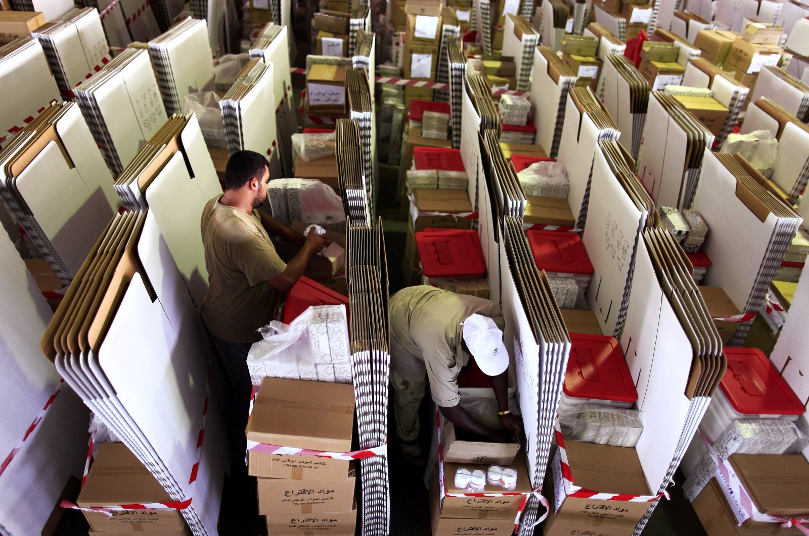 High Election commission workers do a final check on voting equipment before distributing to polling stations at a shed in Maatika airport, Tripoli, July 3, 2012. (Reuters File Photo)