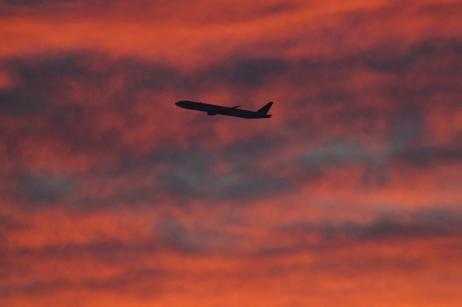 A plane is seen shortly after take-off at sunset, from Heathrow Airport, London, Britain, Dec. 11, 2020. (Reuters Photo)