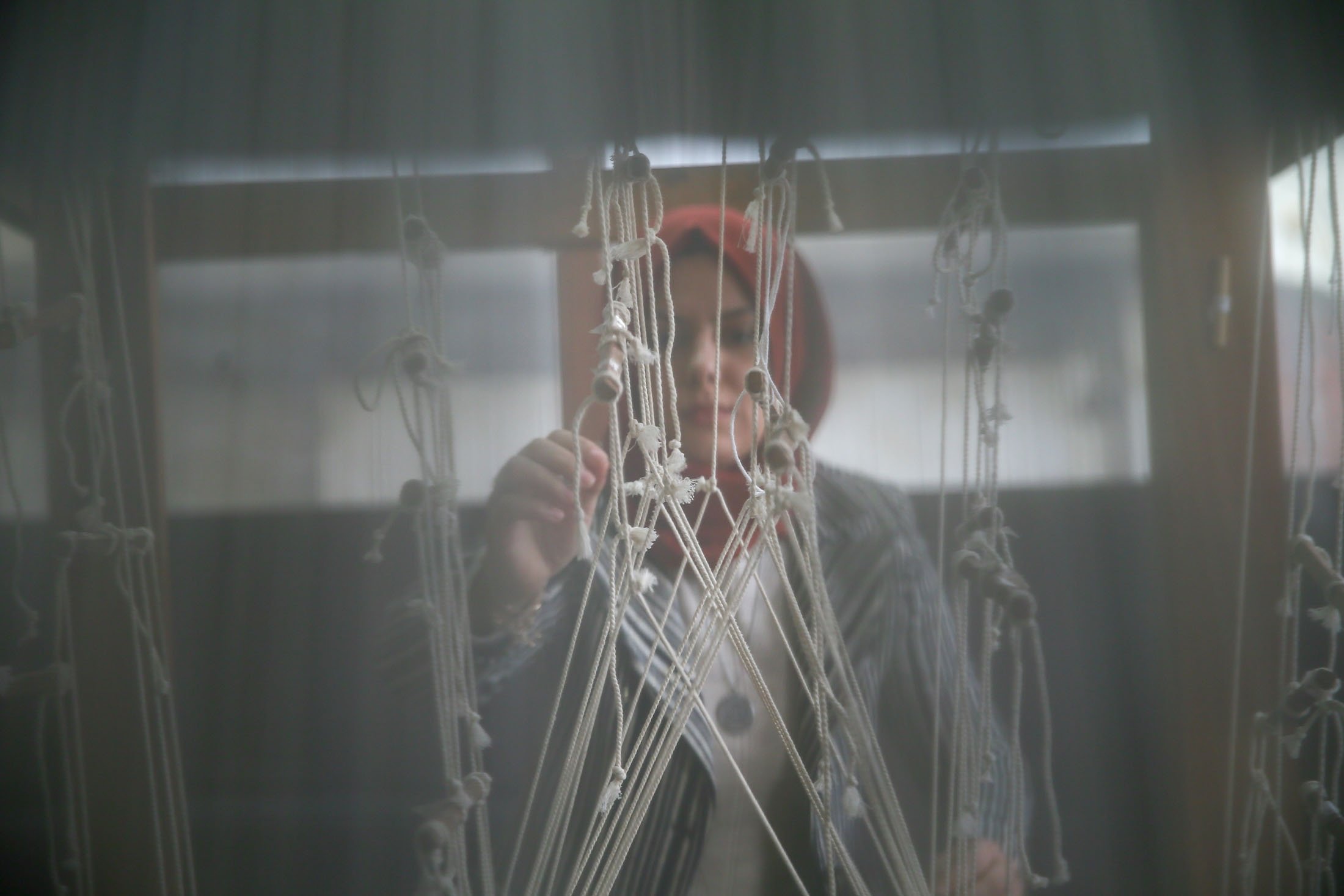 Nurefşan Yaykal keeps the traditional Beledi weaving method alive in her workshop, in Tire district of Izmir, Turkey, Dec. 14, 2021. (AA Photo)
