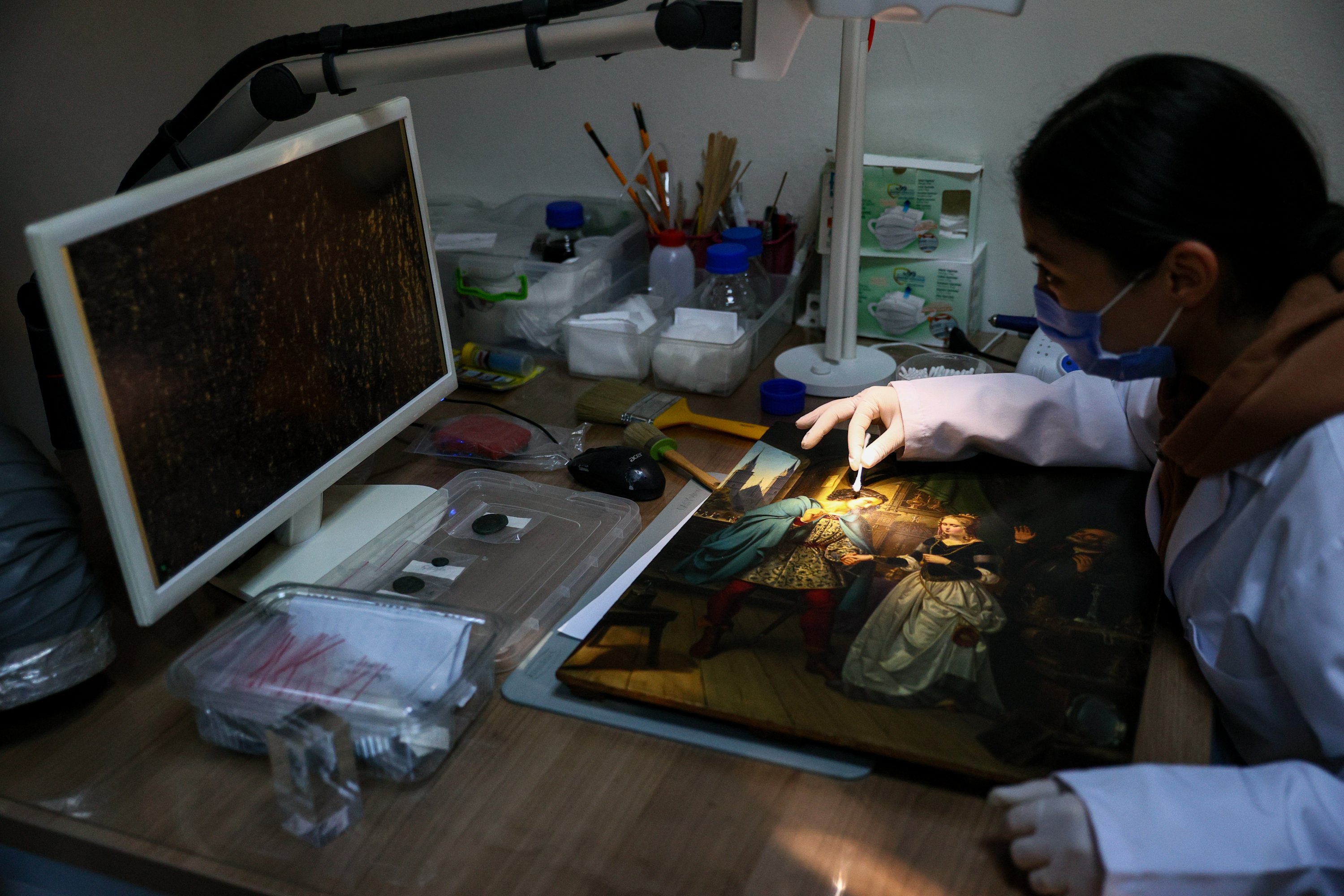 An expert works on a painting in the laboratories of the Izmir Archaeological Museum, Izmir, western Turkey, Dec. 20, 2021. (AA) 