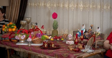 A Yalda Night table is prepared with gifts and fruits including pomegranate, watermelon, cakes and pastries, in line with a book by Hafez. (Shutterstock)