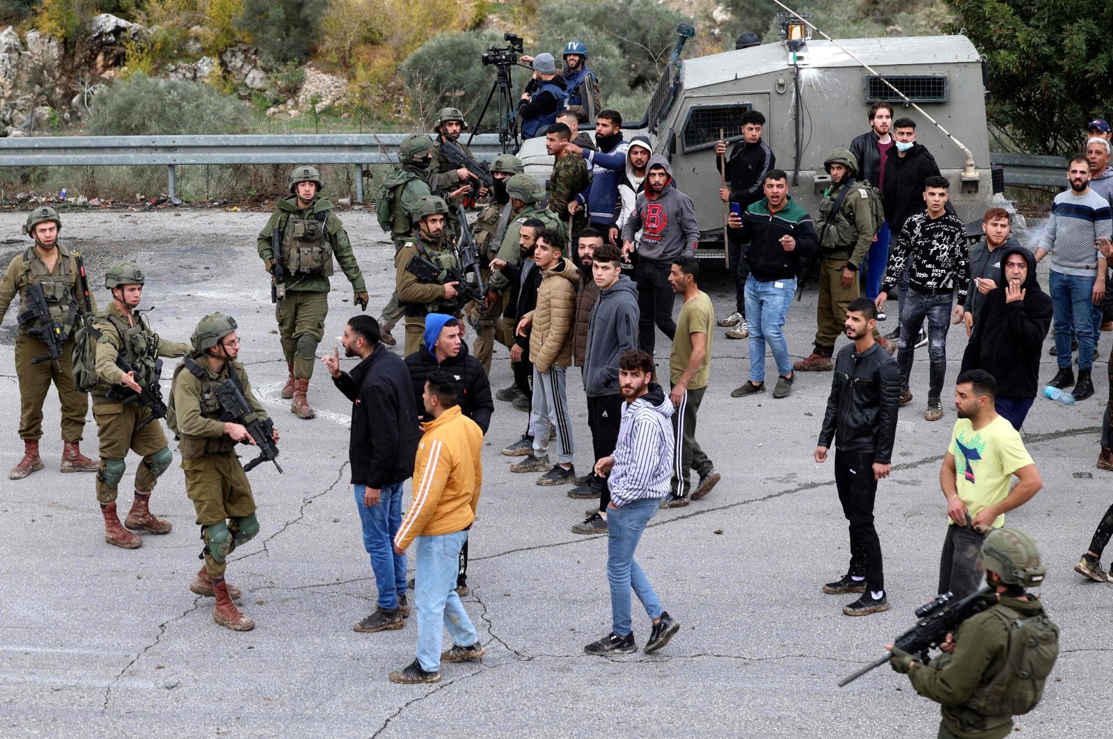 Palestinian residents of Burqah close the road leading to their village and confront Israeli soldiers, the occupied West Bank, Palestine, Dec. 17, 2021. (AFP Photo)