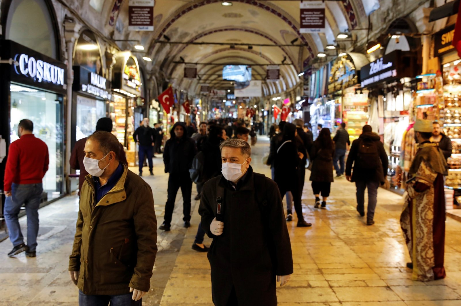 People wear protective face masks due to coronavirus concerns in historic Grand Bazaar, Istanbul, Turkey, March 16, 2020. (Reuters Photo)