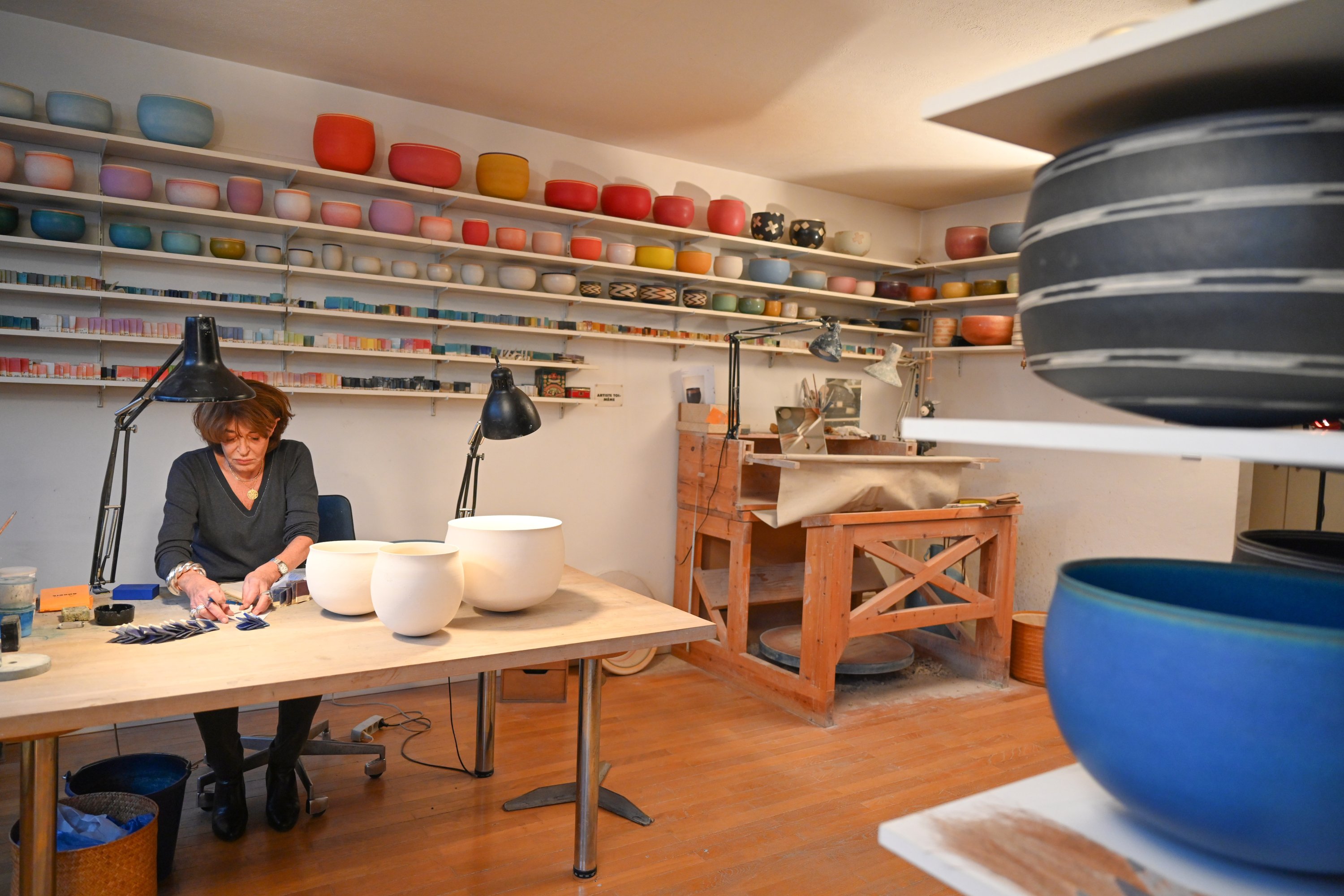 Alev Ebüzziya works in her workshop in Paris, France, Dec.15, 2021. (AA Photo)