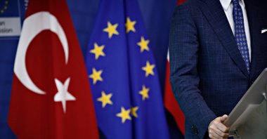 A man stands next to flags of the European Union and Turkey at the headquarters of the European Commission in Brussels, Belgium, July 25, 2017. (Shutterstock File Photo)