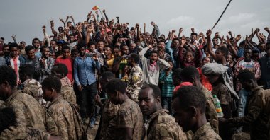 People react as captive Ethiopian soldiers walk towards Mekele Rehabilitation Center in Mekele, the capital of Tigray region, Ethiopia, on July 2, 2021. (AFP Photo)