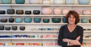 Alev Ebüzziya poses in front of her vessels in her workshop in Paris, France, Dec.15, 2021. (AA Photo)