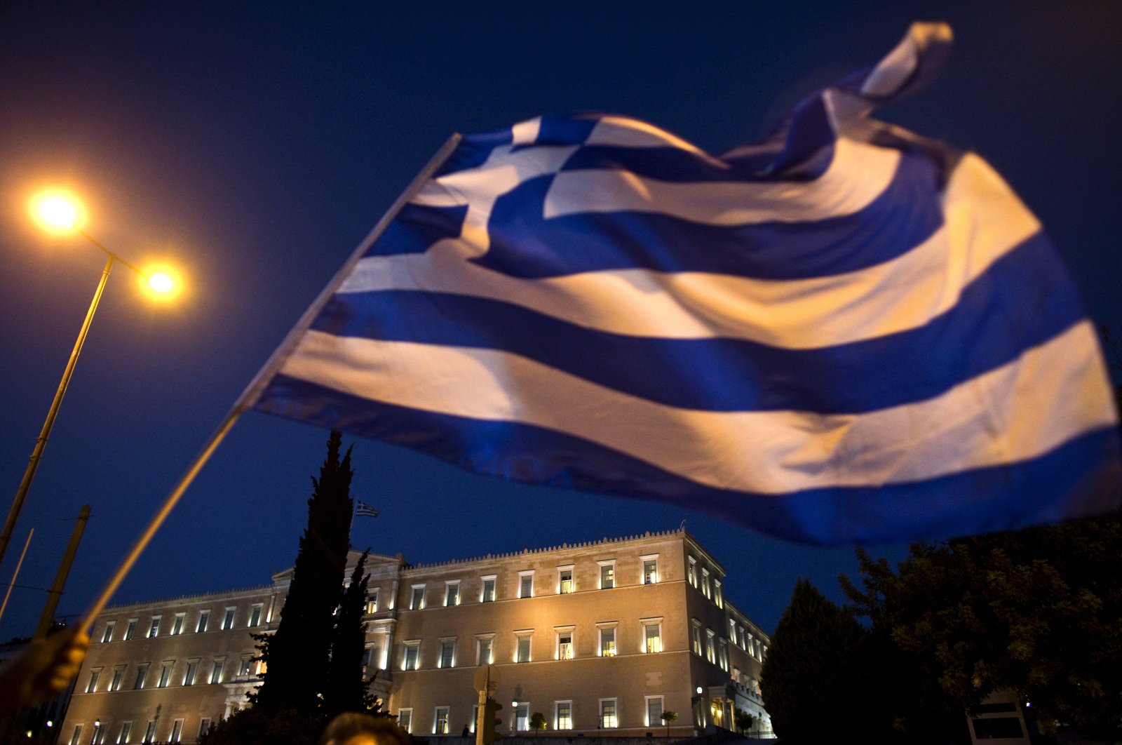The Greek parliament is seen behind a flag during an anti-austerity rally in Athens, Greece, July 22, 2015. (Reuters File Photo)