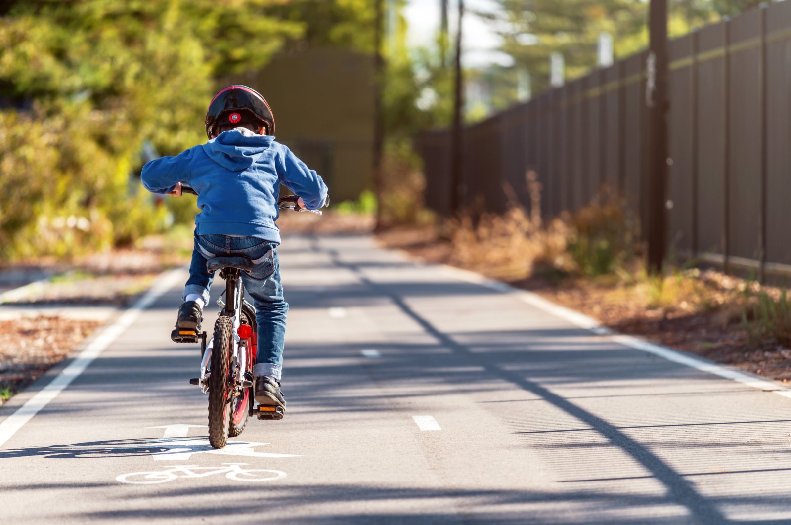 A boy riding his bicycle on the bike lane. (Shutterstock Photo)