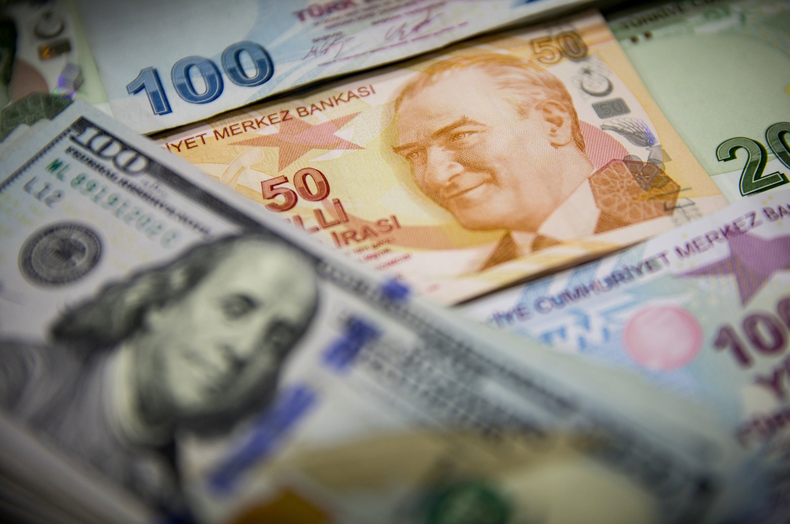 The Turkish lira and U.S. dollar banknotes are pictured together in a photo taken in Turkey. (Photo by Getty Images)