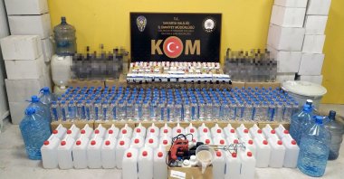 Police in northwestern Sakarya province exhibit gallons containing ethyl alcohol, empty bottles and other equipment used in bootleg liquor production, Turkey, Dec. 22, 2021. (IHA Photo)