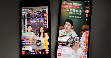 Livestreaming sessions by Chinese livestreamers Li Jiaqi and Viya, whose real name is Huang Wei (L), are seen on Alibaba's e-commerce app Taobao displayed on mobile phones in this illustration picture taken Dec. 14, 2021. (Reuters Photo)