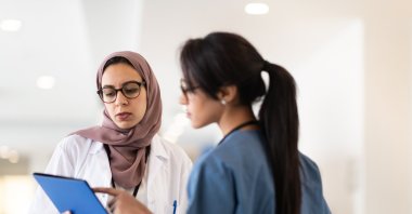 Two female doctors converse in a hallway of a hospital (Getty Images File Photo)
