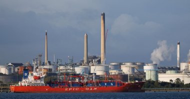The MV Epic St George LNG (liquid natural gas tanker) passes the Esso Oil refinery in Fawley, near Southampton, southern England, Oct. 4, 2021. (AFP Photo)