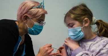 A child receives a dose of the Pfizer-BioNTech COVID-19 vaccine at the Clemenceau rehabilitation center in Strasbourg, France, Dec. 22, 2021. (AFP Photo)