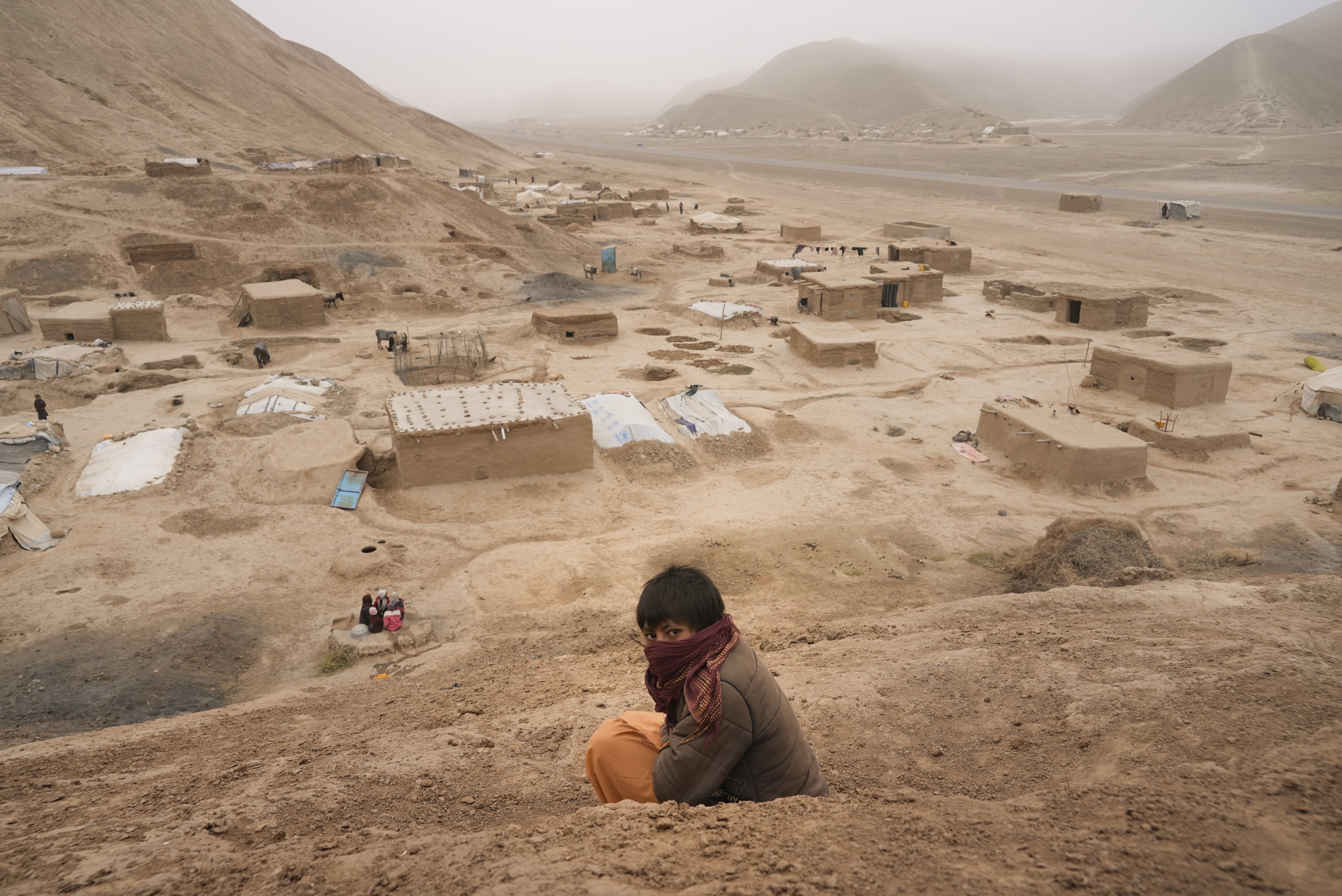 An Afghan boy sits on the hill overlooking the IDP camp near Qala-e-Naw, Afghanistan, Dec. 14, 2021. (AP Photo)