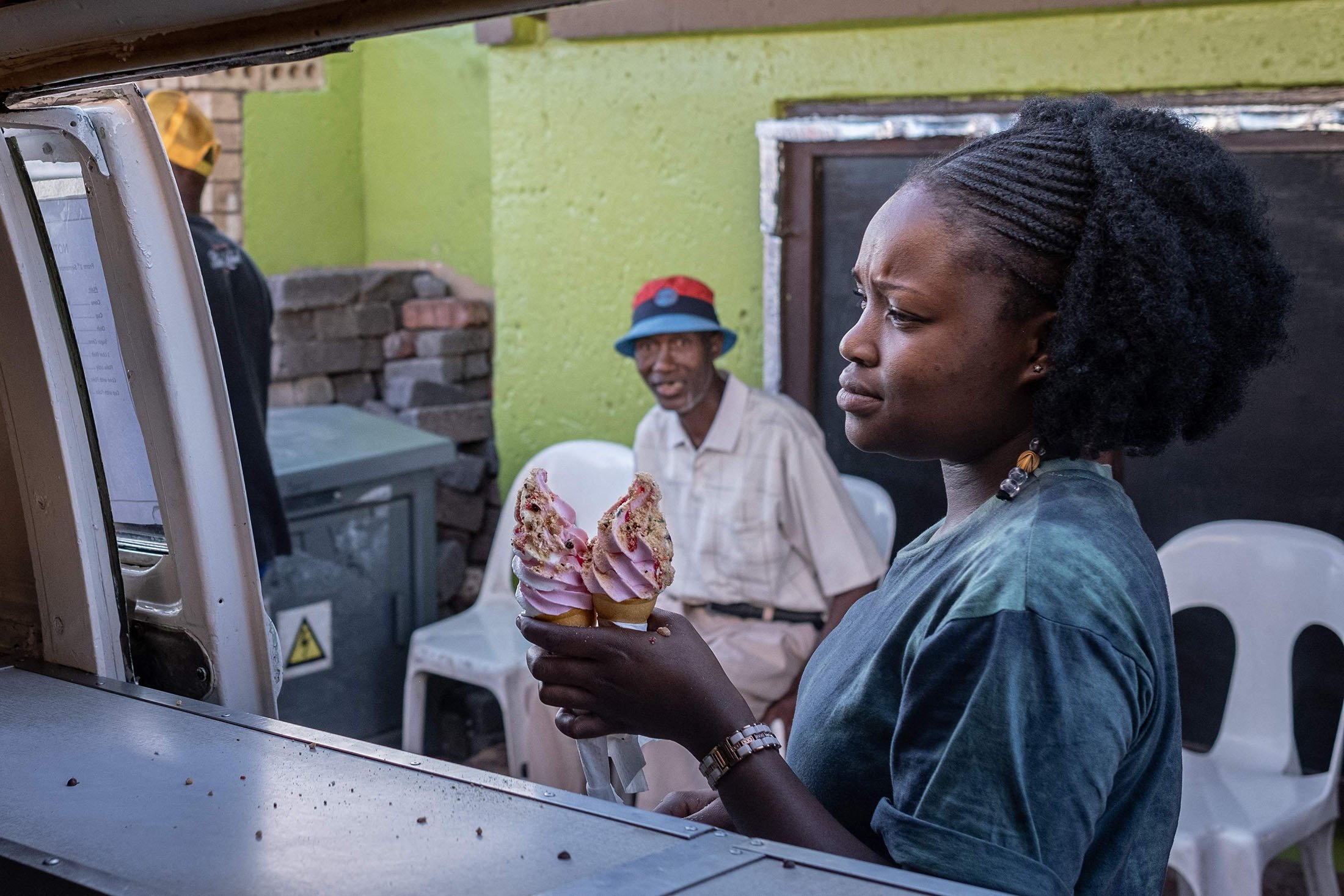 A customer buys ice cream from Sipho Mtshali's ice cream truck in Soweto, South Africa, Nov. 19, 2021. (AFP Photo)