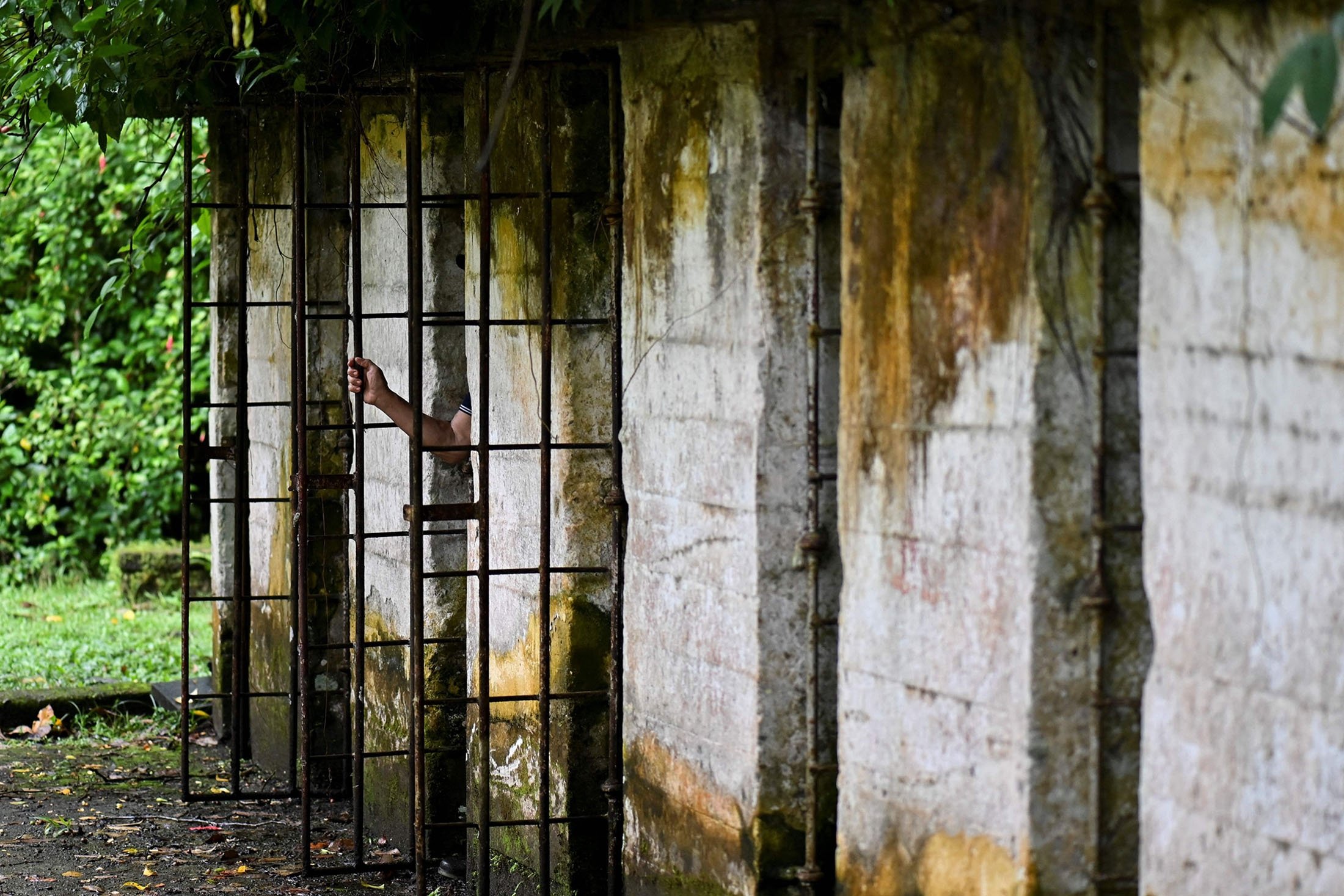 A tourist steps out of a cell at what was the prison at Gorgona Island, in the Pacific Ocean, off southwestern Colombia, Dec. 1, 2021. (AFP Photo)