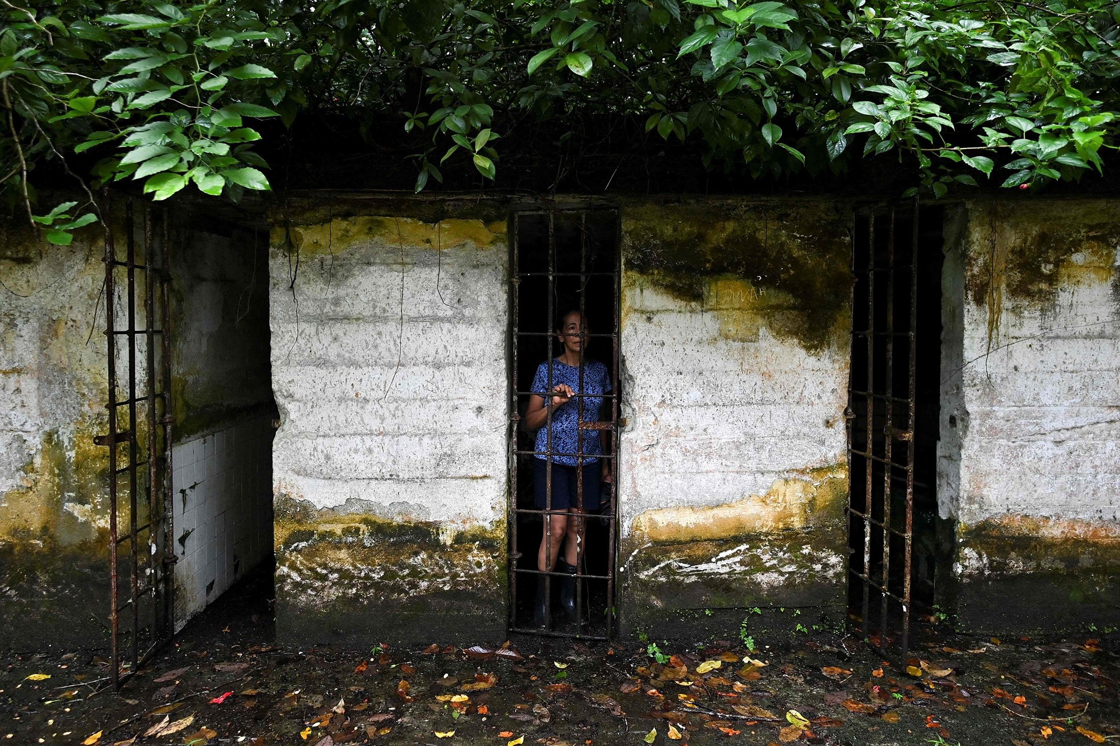 A tourist poses for a picture inside a cell at what was the prison at Gorgona Island, in the Pacific Ocean, off southwestern Colombia, Dec. 2, 2021. (AFP Photo)