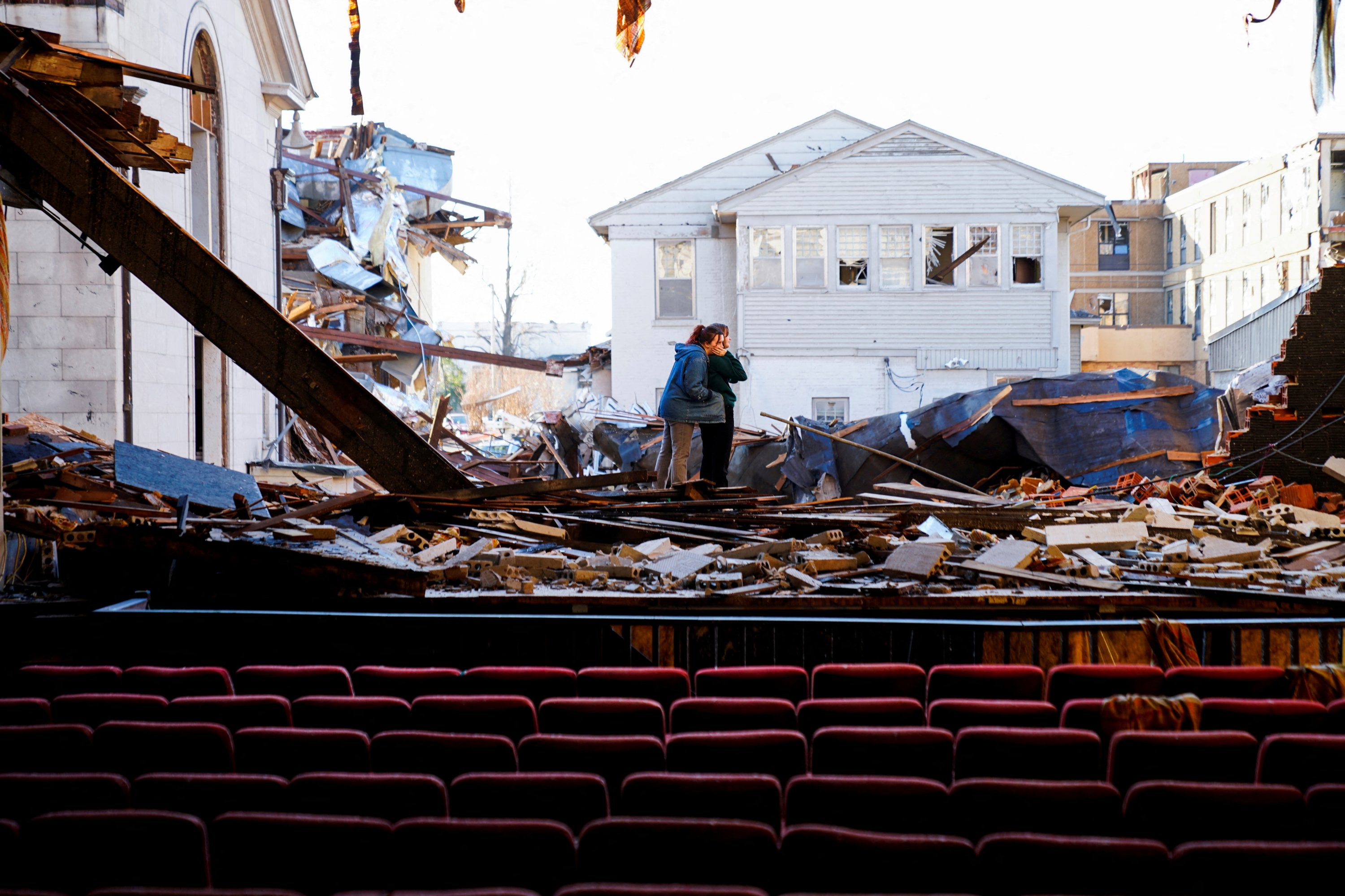 Sisters Julianna Sims, 21, and Natalie, 15 comfort each other while visiting the destroyed theater at the American Legion after a devastating outbreak of tornadoes ripped through several U.S. states in Mayfield, Kentucky, U.S., Dec. 19, 2021. (Reuters Photo)