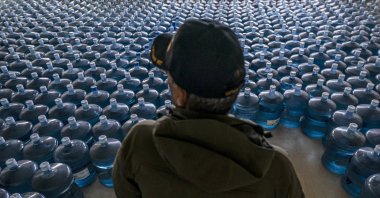Dan Martinez, emergency manager for the Confederated Tribes of Warm Springs, pauses in a classroom used to store donated water in, Warm Springs, Oregon, U.S., Dec. 7, 2021. (AP Photo)