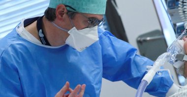 A medical personnel works at the intensive care unit for patients suffering from the coronavirus disease, at ZNA Stuivenberg hospital in Antwerp, Belgium, Nov. 19, 2021. (REUTERS)