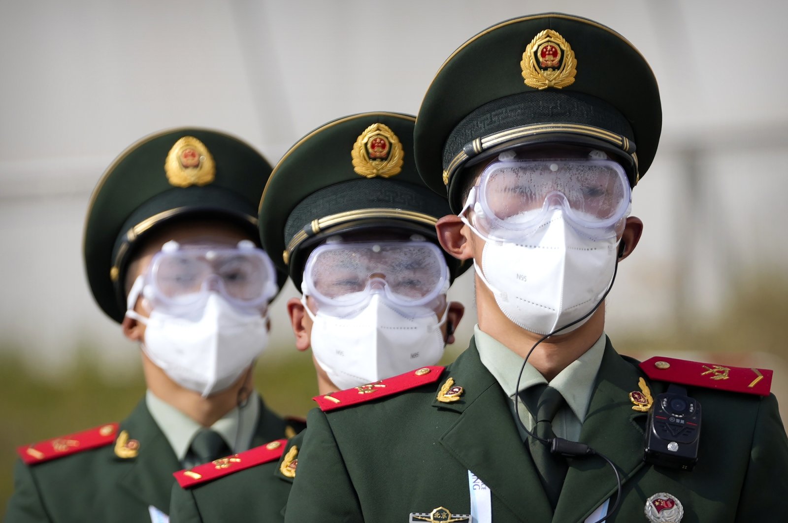 Chinese paramilitary police in goggles and face masks march during a 2022 Winter Olympics test event, Beijing, China, Oct. 25, 2021. (AP Photo)