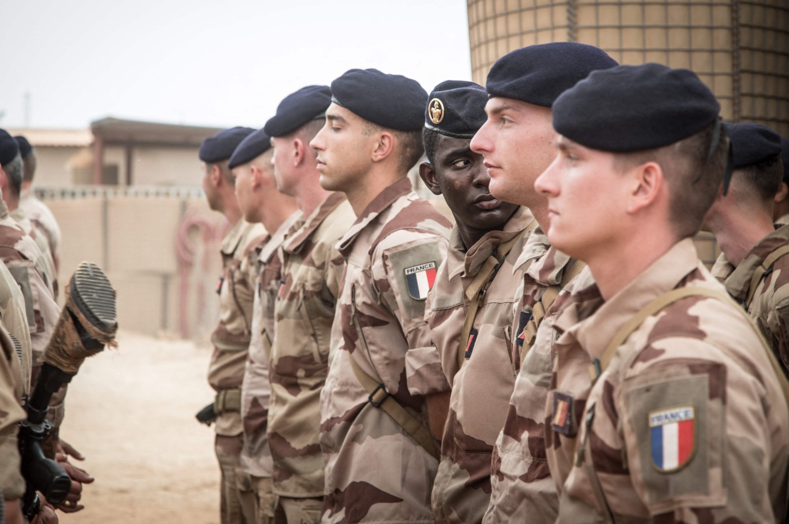 French soldiers from Operation Barkhane stand at attention as they wait for the handover ceremony of the Barkhane military base to the Malian army in Timbuktu, on Dec. 14, 2021. (AFP)