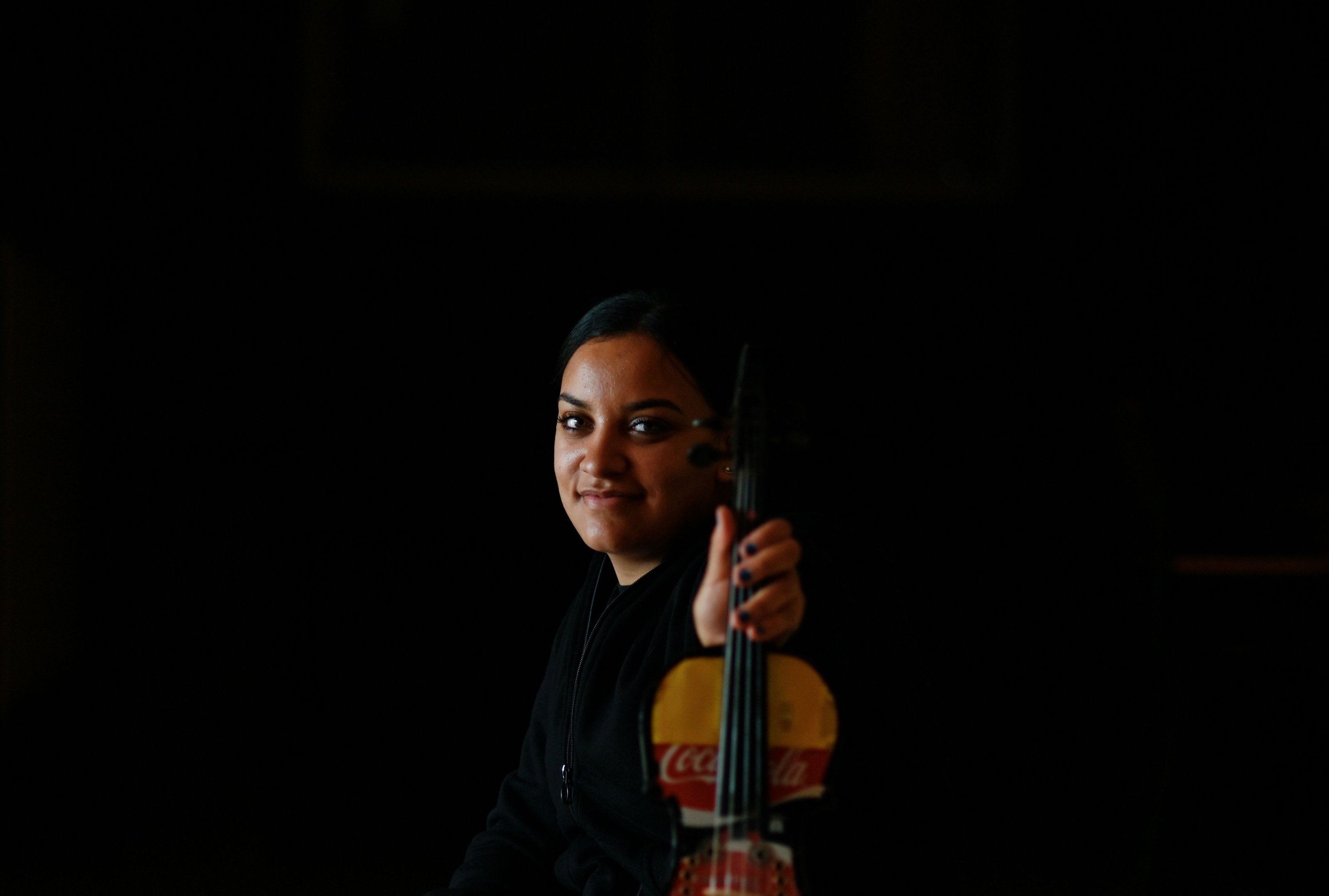 Cristina Vazquez, 18, member of the "Music of Recycling" orchestra, poses with her violin in Madrid, Spain, Dec. 18, 2021. (AFP Photo)