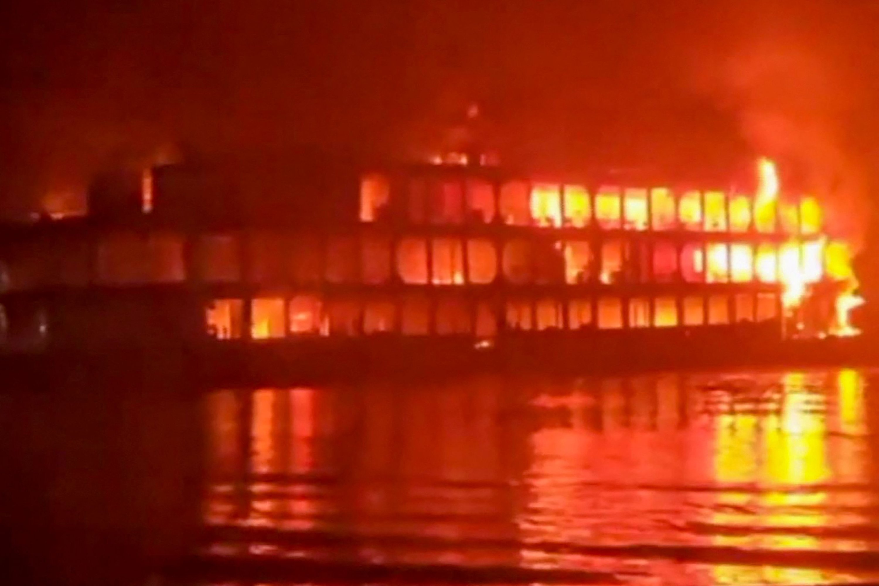 This frame grab from an AFPTV video shows a burning ferry after it caught on fire killing at least 39 people in Jhakakathi, 250 kilometers (160 miles) south of Dhaka, December 24, 2021. (AFP Photo)