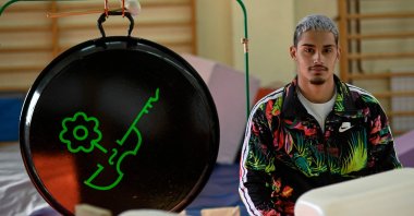 Luis Miguel Munoz, 18, member of the "Music of Recycling" orchestra poses during a rehearsal in Madrid, Spain, Dec. 18, 2021.(AFP Photo)
