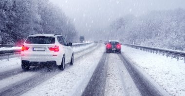 An SUV drives on a German highway amid snowfall. (Shutterstock Photo)
