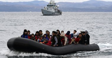 Migrants arrive in a dinghy accompanied by a Frontex vessel at the village of Skala Sikaminias on the island of Lesbos, Greece, Feb. 28, 2020. (AP Photo)