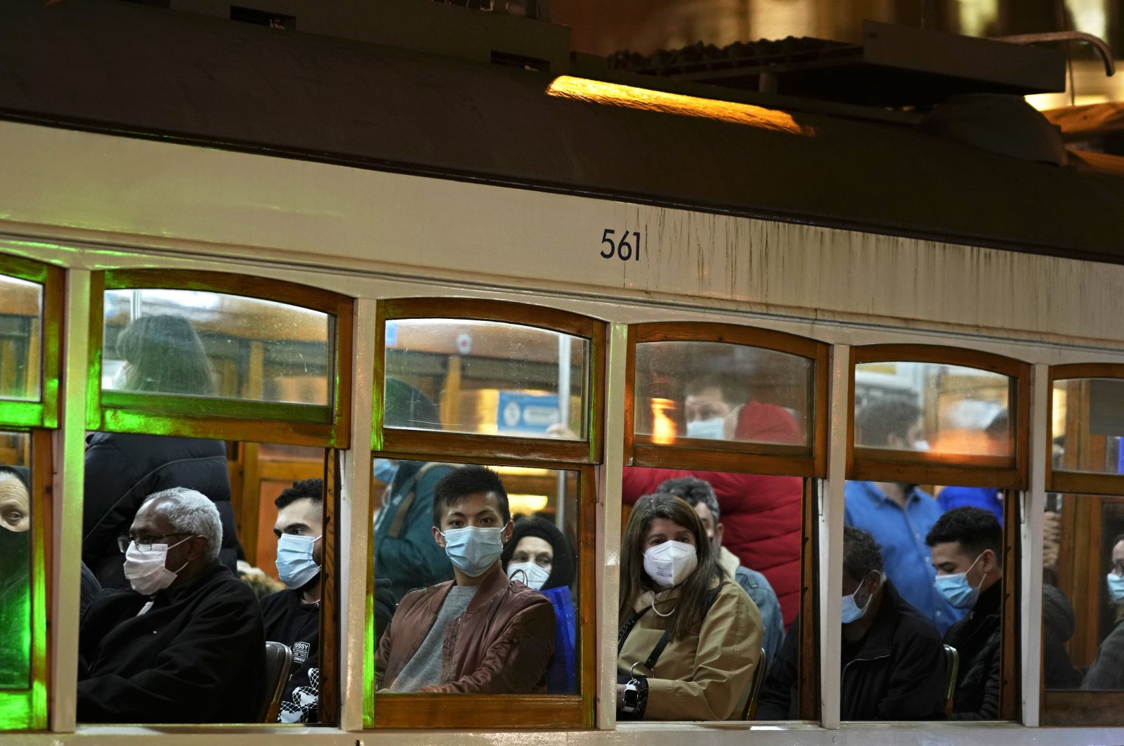 People wearing face masks ride a tram in Lisbon, Dec. 22, 2021. (AP Photo)