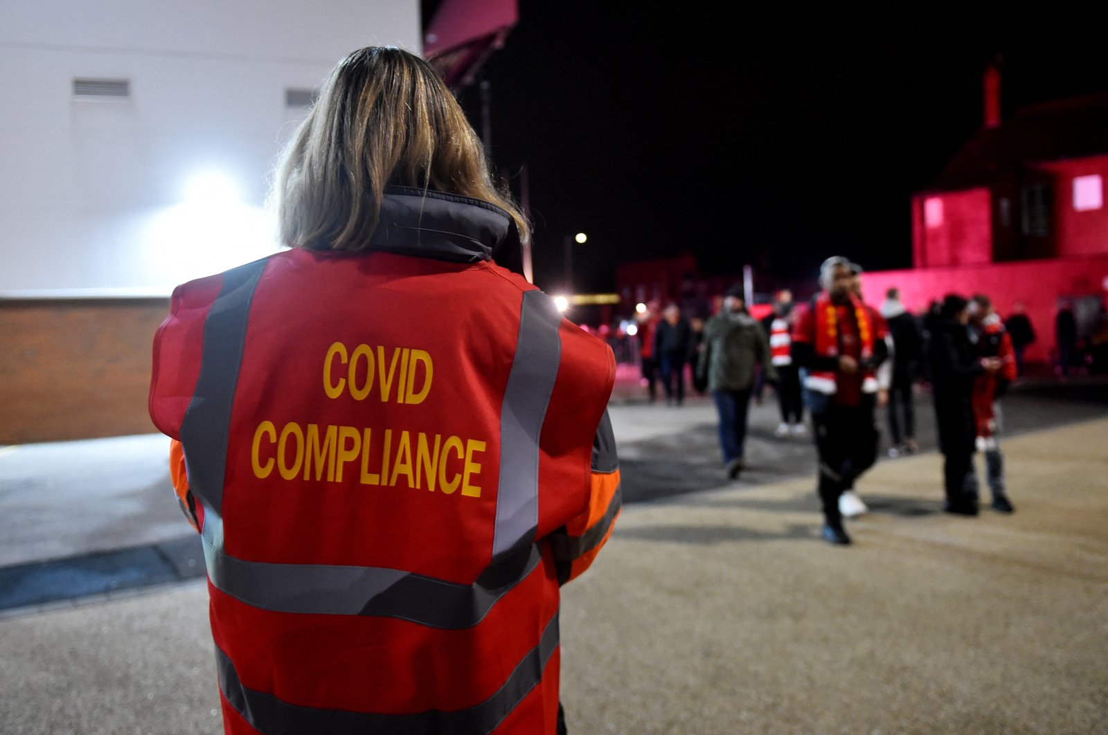 A member of the COVID-19 compliance team is seen outside Anfield before a Premier League match between Liverpool and Newcastle, Liverpool, England, Dec. 16, 2021. (Reuters Photo)