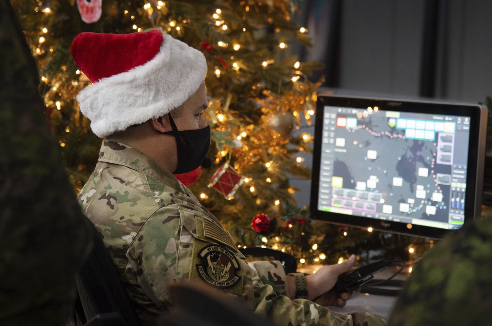 In this photo provided by the North American Aerospace Defense Command, a 22 Wing member is seen showing how they track Santa on his sleigh on Christmas Eve during a media preview at the Canadian Forces Base in North Bay, Canada, Dec. 9, 2021. (NORAD via AP)