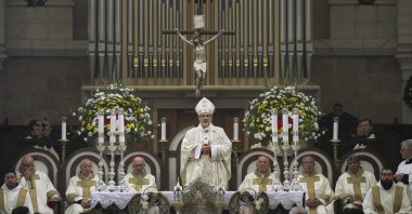 Latin Patriarch Pierbattista Pizzaballa, the top Catholic clergyman in the Holy Land (C), leads the Christmas morning Mass at the Church of the Nativity, traditionally believed to be the birthplace of Jesus Christ, in the West Bank town of Bethlehem, Palestine, Dec. 25, 2021.  (AP Photo)