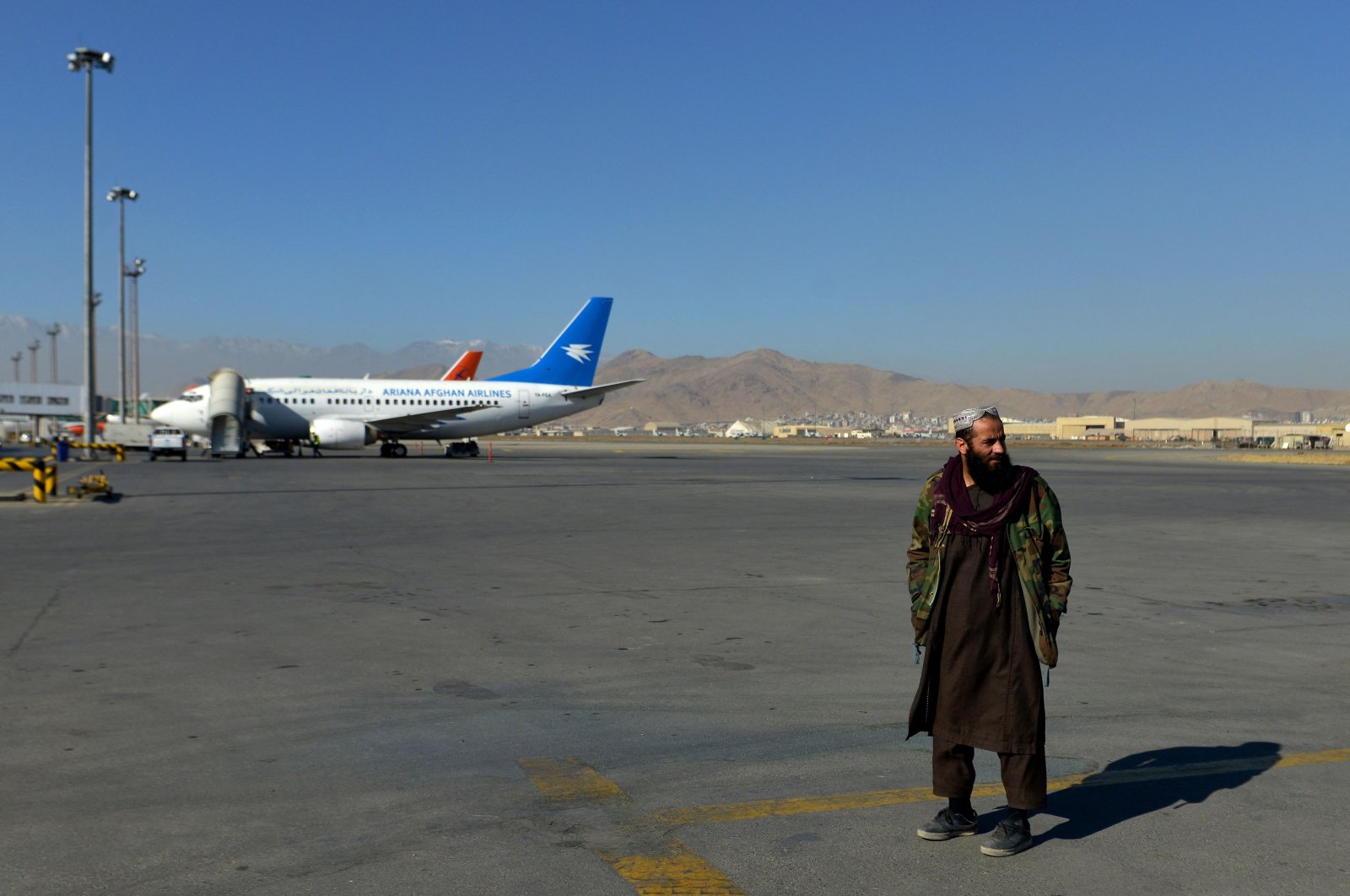 A member of the Taliban stands on the runway at the Kabul airport in Kabul, Afghanistan, Dec. 8, 2021. (AFP File Photo)