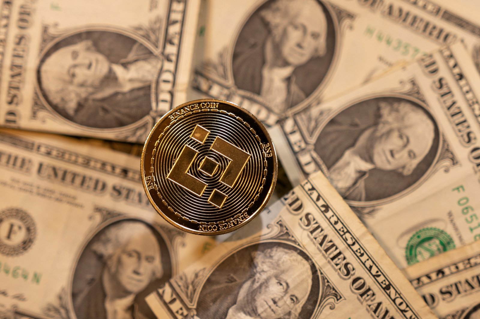 A representation of the virtual cryptocurrency Binance is placed on U.S. dollar banknotes in this illustration taken Nov. 28, 2021. (Reuters Photo)