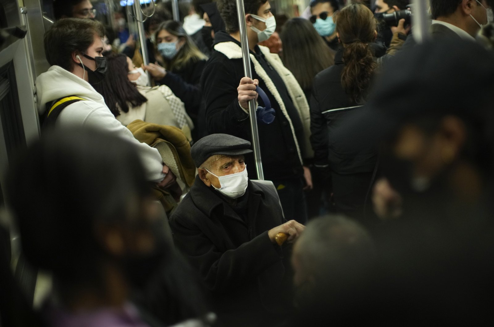 People, all wearing masks to prevent the spread of COVID-19, take a ride on a metro train in Istanbul, Turkey, Dec. 2, 2021. (AP Photo)