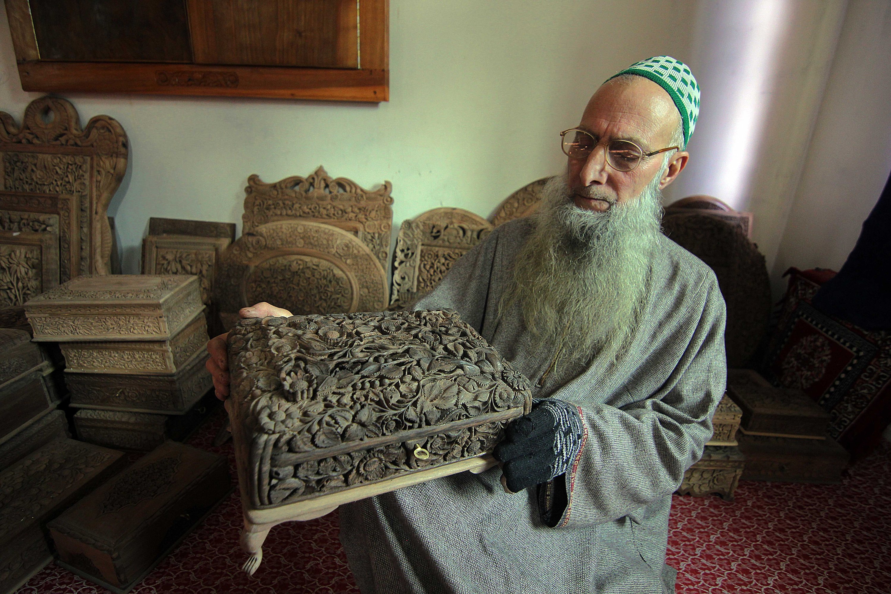 Craftsman Ghulam Nabi Dar shows a hand-carved wooden box in Kashmir, March 14, 2021. (AA) 