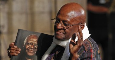 Former South African Archbishop Desmond Tutu poses with a copy of the book 'Tutu: The Authorised Portrait' during an event for the book launch in Cape Town, South Africa, Oct. 6, 2011. (EPA Photo)