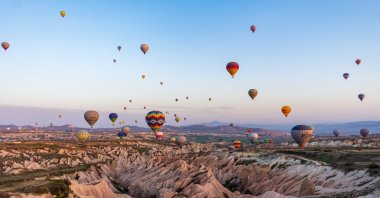 Hot air balloons dot the sky in Cappadocia, Turkey. (Shutterstock Photo)
