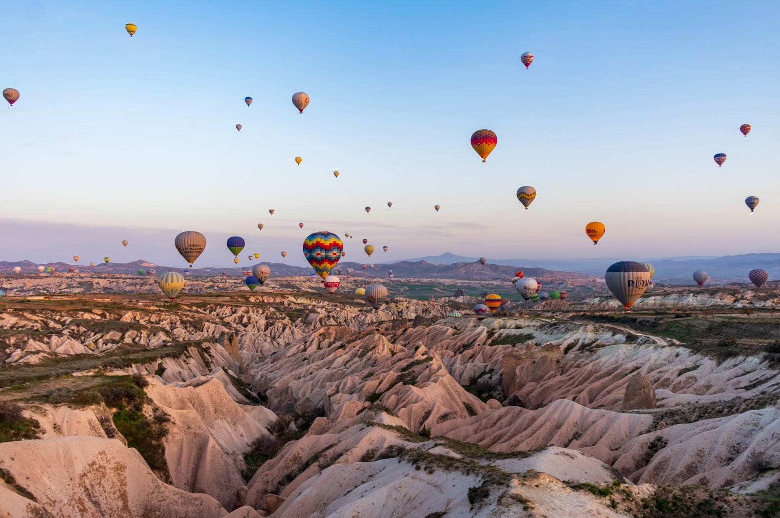 Hot air balloons dot the sky in Cappadocia, Turkey. (Shutterstock Photo)
