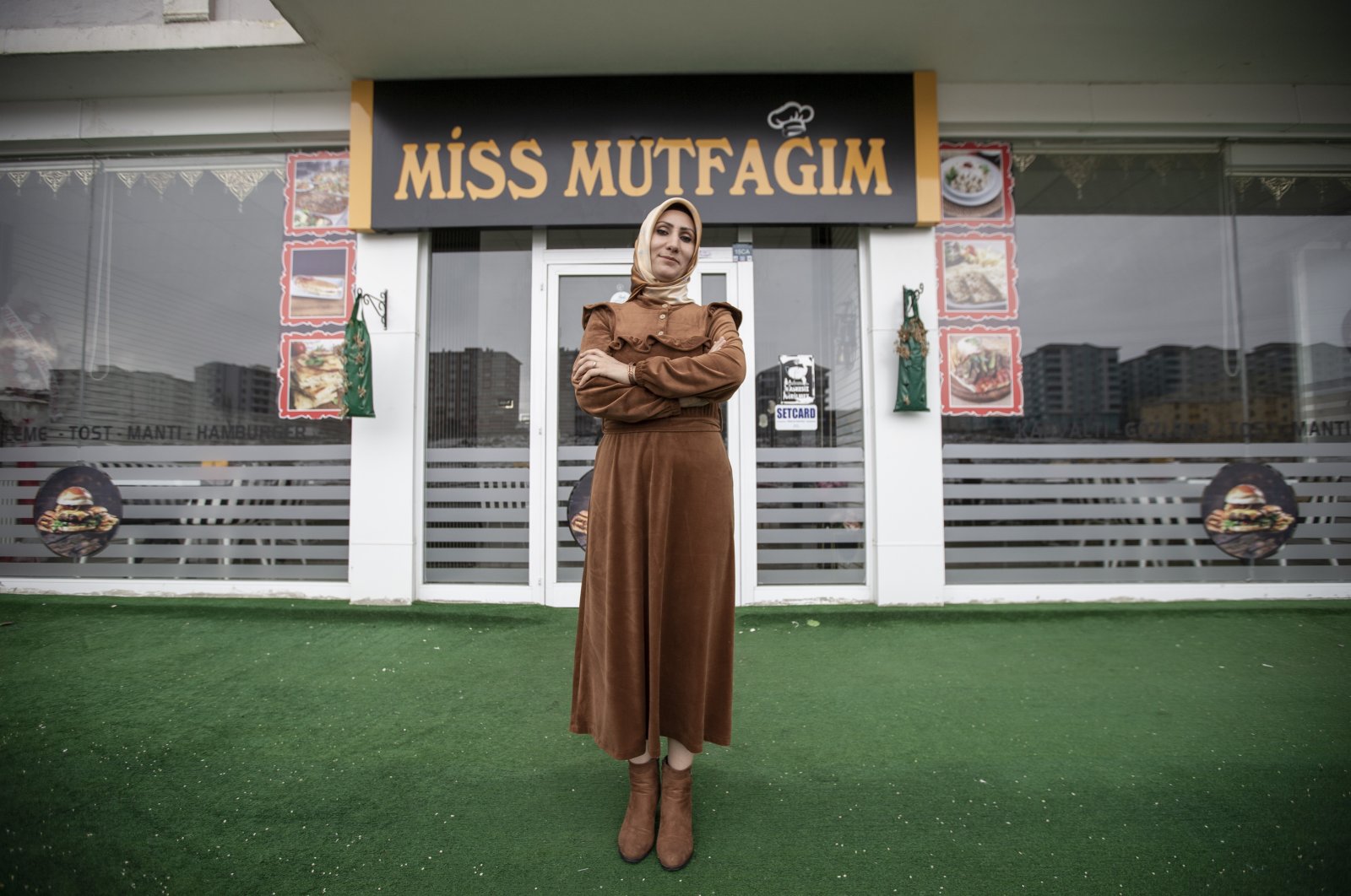 Female entrepreneur Yasemin Bülbül standing in front of her catering business, &quot;Miss Mutfağım,&quot; she started with a government grant in Erzurum, eastern Turkey, Dec. 9, 2021. (AA Photo)