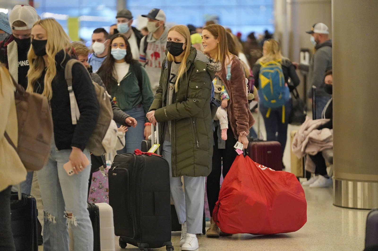 Holiday travelers wait in line at Salt Lake City International Airport, in Salt Lake City, Utah, U.S., Dec. 24, 2021. (AP Photo)
